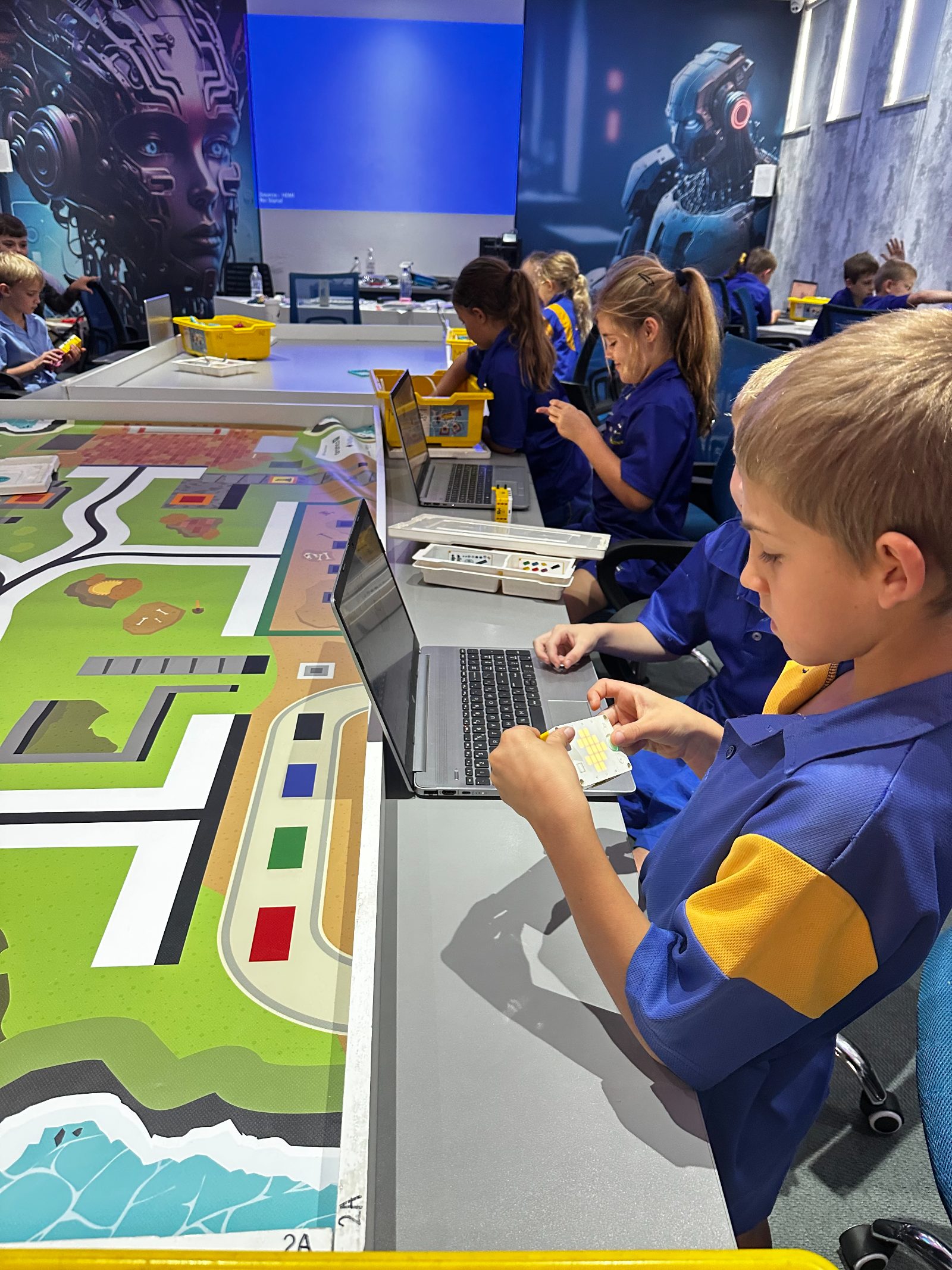 Robotics Army class with laptops and game mats